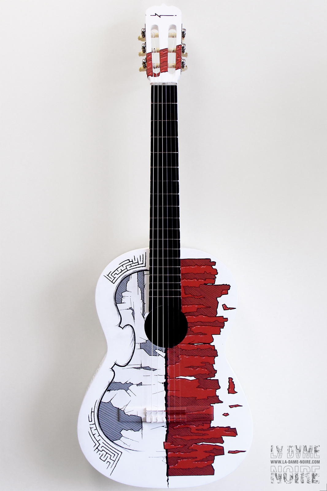 Front side of an acoustic guitar painted in white with the shape of a violin drawed on it