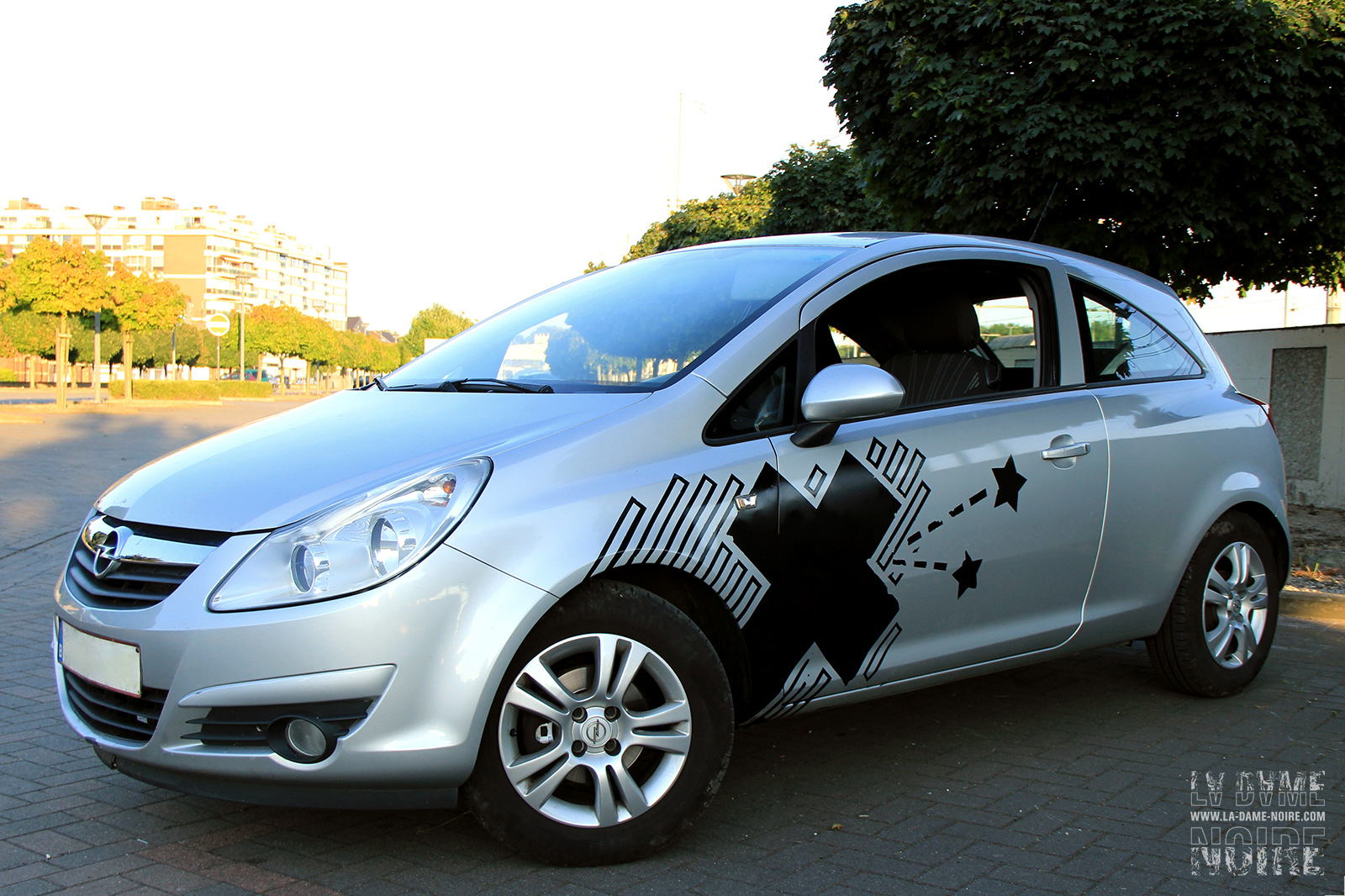 Left side of a car painted with stars a big black cross