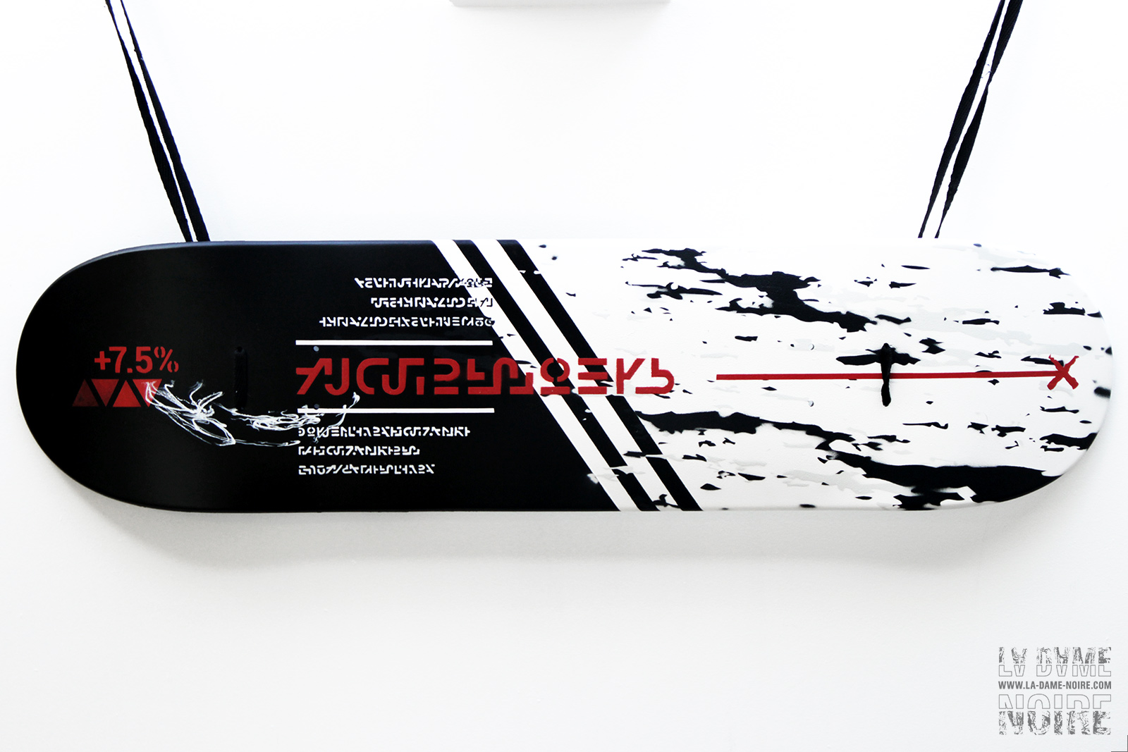 Skateboard customized with spray can in black and white with red stripes