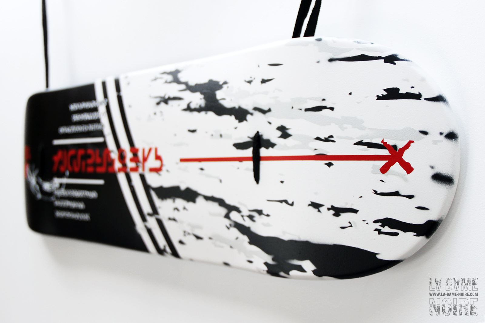 Details of the skateboard paint in white and black stripes with a red cross